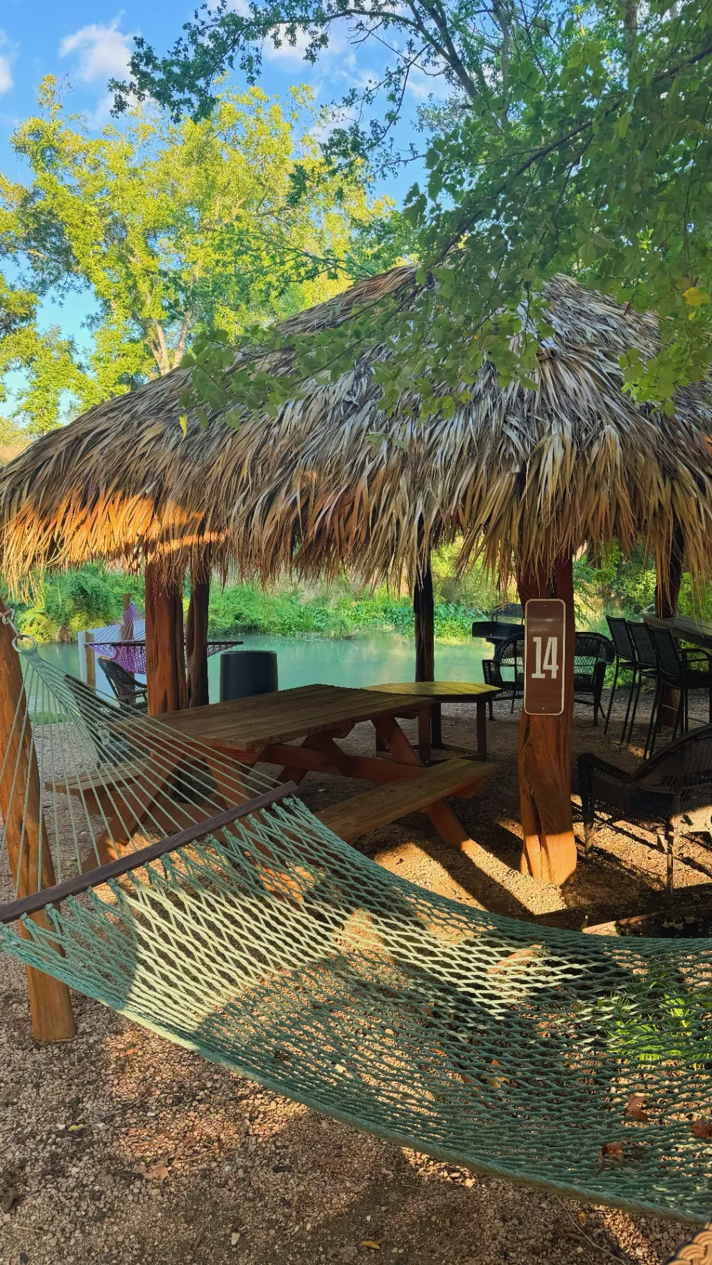 Family enjoying a riverside cabana at Son's River Ranch on the San Marcos River