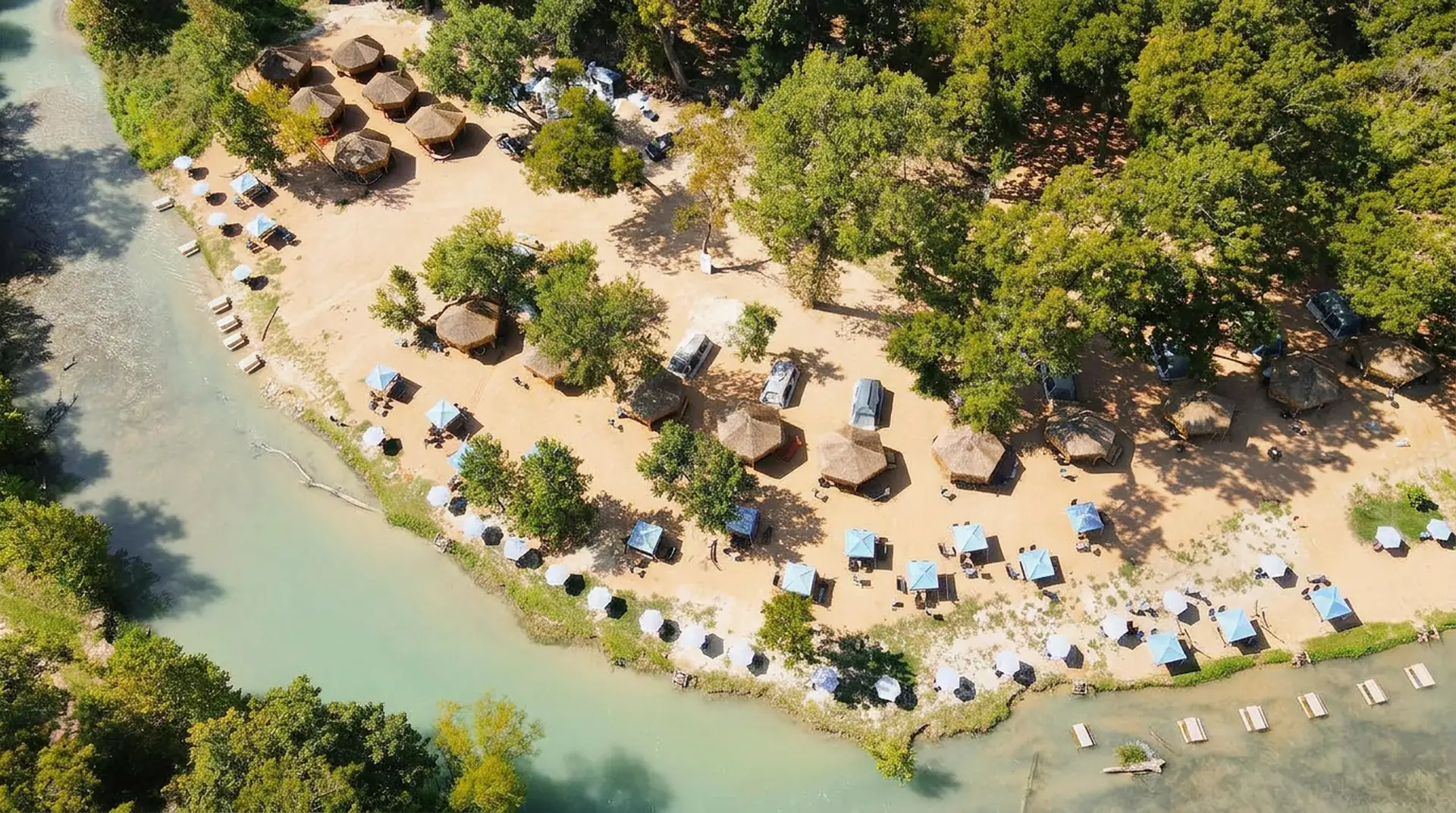 Aerial drone view of Son's River Ranch — riverside glamping cabins on the San Marcos River, Texas