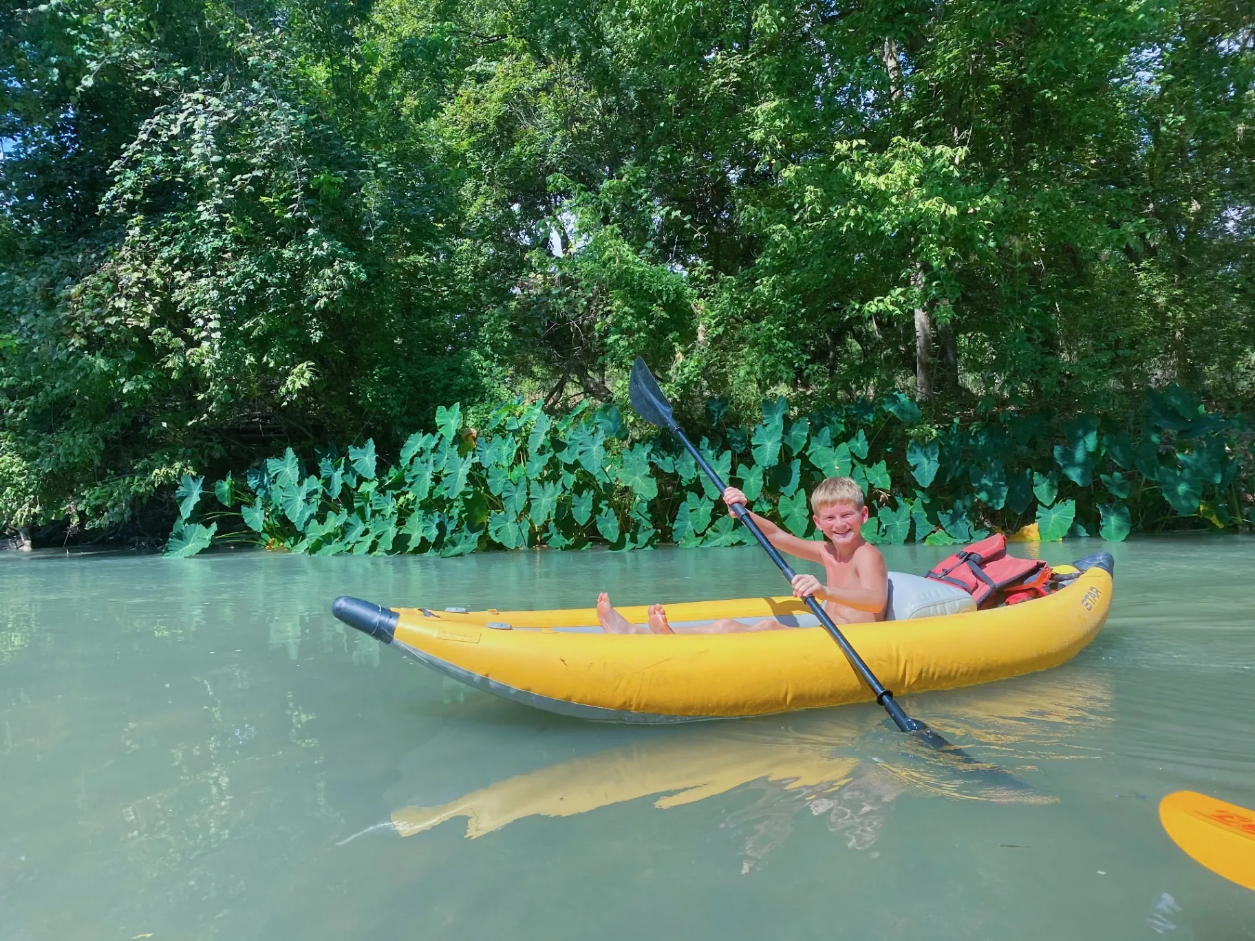 Kid kayaking on the river