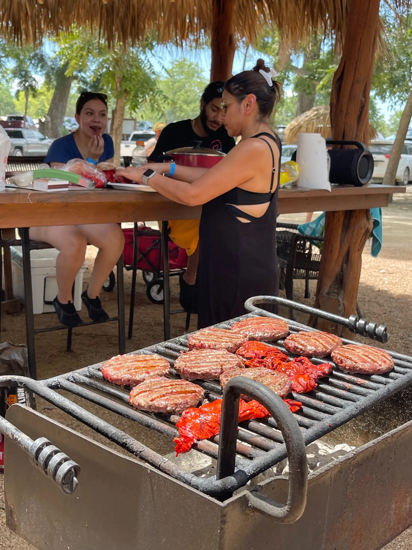 Guests grilling under the tiki hut