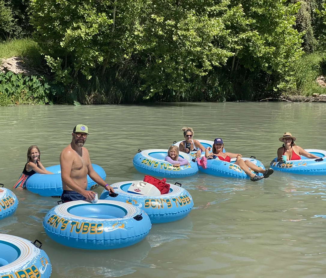 Family floating on tubes in the river