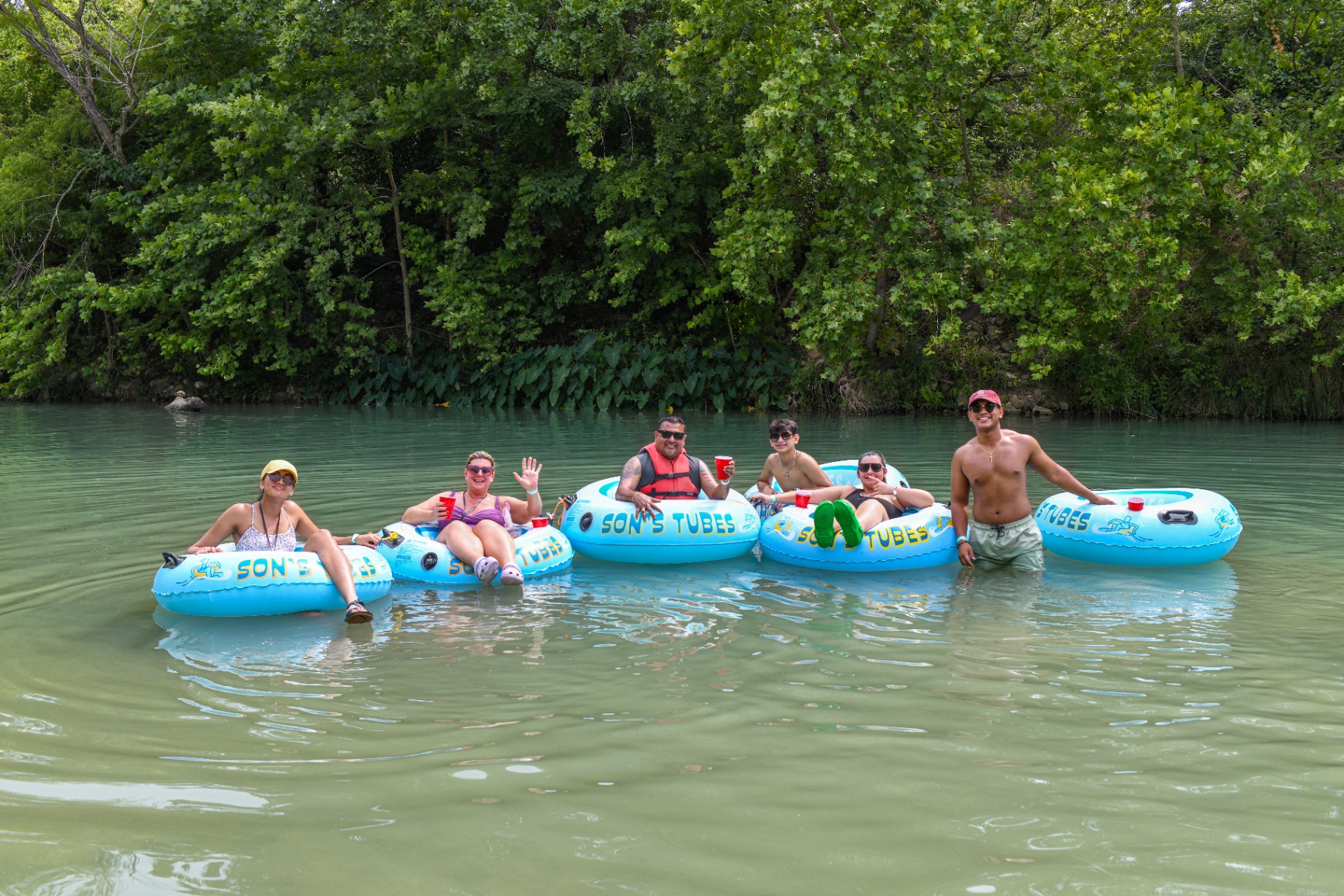 Friends tubing together on the river